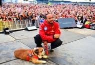 Lewis Hamilton of Great Britain and Scuderia Ferrari poses with Roscoe - Source: Getty Images